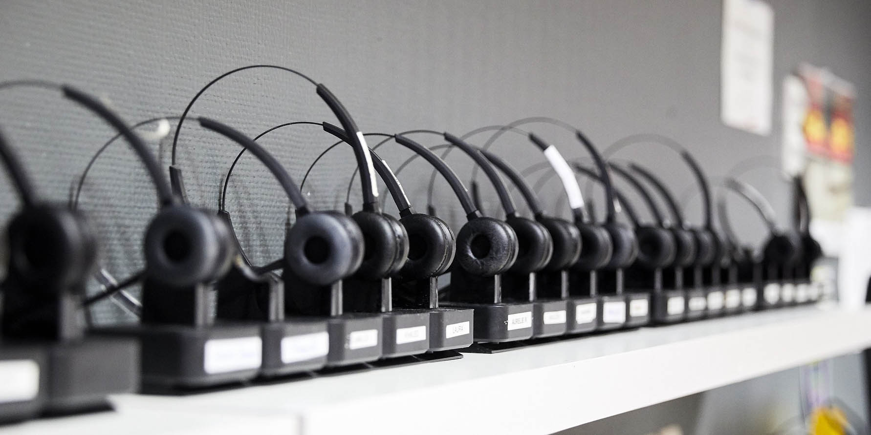 call center agent headsets sitting on a shelf